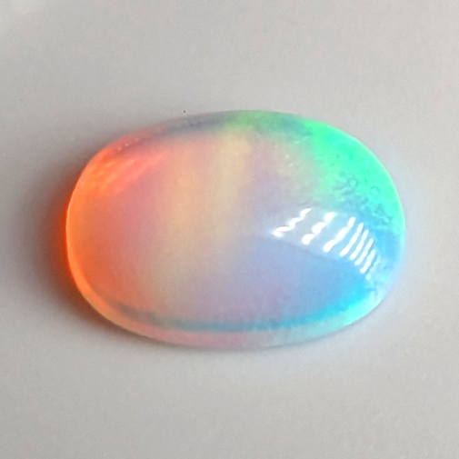 Lab Created Opal:  Oval Cabochon Aurora White Lab Created Opal